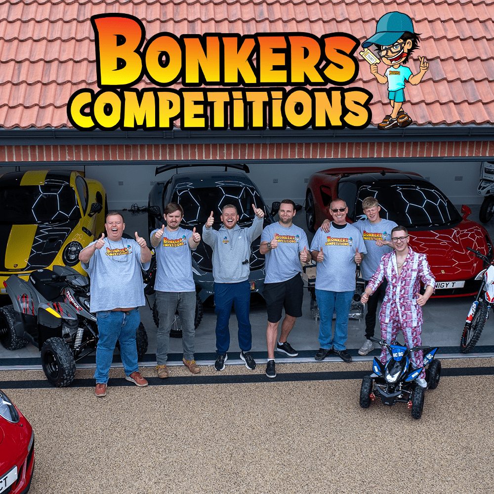 All of the bonkers staff in front of different prizes offered up in competitions